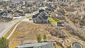 Aerial view of property and surrounding area with nearby suburban area