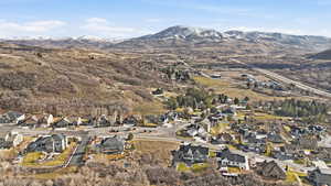 Aerial overview of property's location featuring nearby suburban area and a mountainous background
