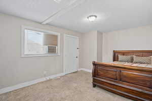 Bedroom with carpet floors and a textured ceiling