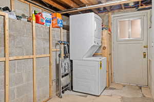 Washroom with stacked washer and clothes dryer
