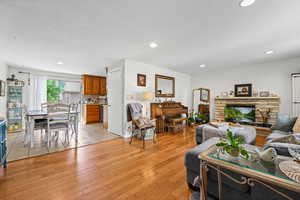 Living room featuring recessed lighting, light wood-style floors, and a textured ceiling