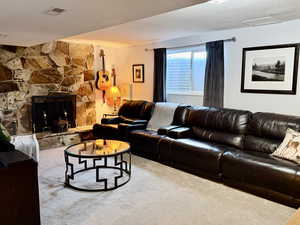 Living area featuring a fireplace and carpet flooring