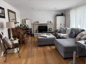 Living area featuring wood-type flooring and a textured ceiling