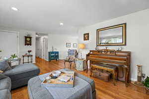 Living room featuring light wood-type flooring and a textured ceiling