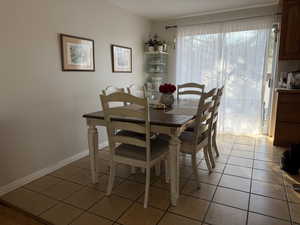 Dining space featuring light tile patterned flooring