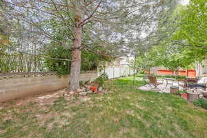 Fenced backyard with a patio