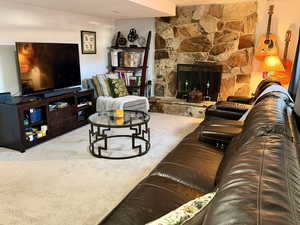 Living area featuring carpet flooring and a fireplace