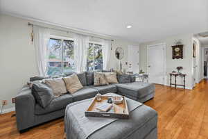 Living area featuring baseboards and hardwood / wood-style floors