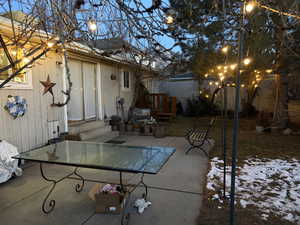 View of patio featuring outdoor dining space, a wooden deck, and entry steps