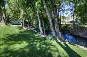 View of yard with a water view