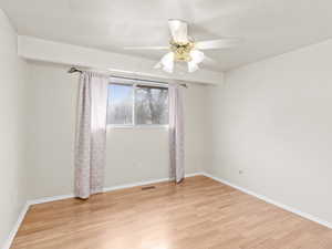 Spare room with light wood-style flooring and a ceiling fan