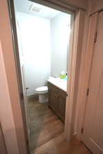 Bathroom featuring vanity and dark wood-style flooring