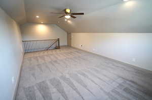 Additional living space featuring vaulted ceiling, carpet flooring, ceiling fan, and recessed lighting