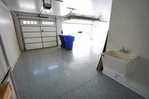 Garage with a sink and a garage door opener