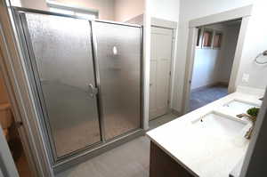 Bathroom with double vanity and a stall shower