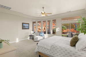 Carpeted bedroom with access to exterior and a ceiling fan