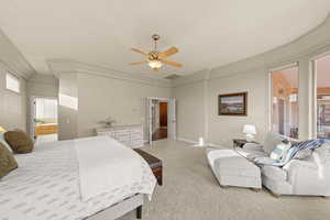 Bedroom with carpet floors, a ceiling fan, and crown molding