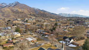 View of mountain backdrop featuring nearby suburban area