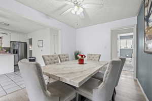 Dining room featuring ceiling fan and a textured ceiling