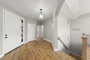 Entrance foyer featuring wood finished floors and baseboards