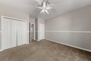 Unfurnished bedroom with carpet flooring, a closet, and ceiling fan