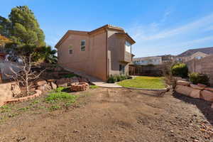 View of side of home with an outdoor fire pit