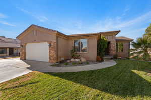 Ranch-style house with stone siding, stucco siding, driveway, a front yard, and an attached garage