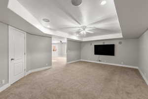 Below grade area with light carpet and recessed lighting