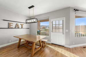 Dining area featuring light wood-style flooring and baseboards