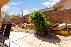 Fenced backyard featuring a patio