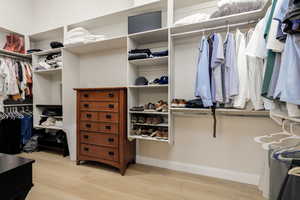 Walk in closet featuring light wood-style flooring