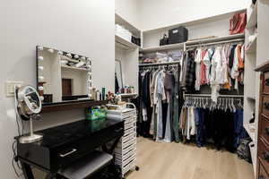 Walk in closet featuring light wood-style flooring