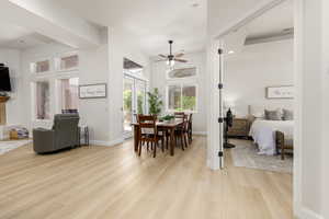 Dining area with light wood-style floors and a ceiling fan