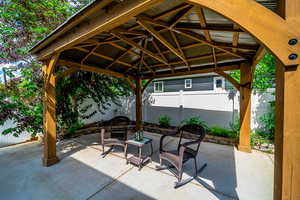 Fenced backyard with a patio area and a gazebo
