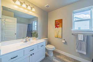 Full bathroom with vanity, curtained shower, and light tile patterned floors