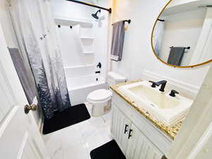 Full bath featuring vanity and shower / bathtub combination with curtain