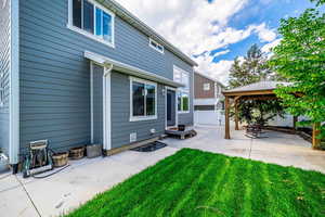 Rear view of property with a gazebo and a patio