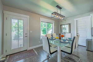 Dining space featuring a textured ceiling and wood finished floors