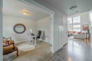 Office space with a textured ceiling and wood finished floors