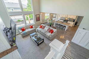 Living area featuring a high ceiling and dark wood-type flooring
