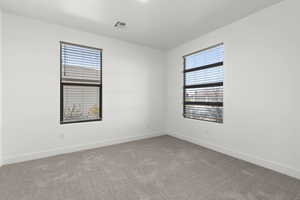 Unfurnished room with carpet and plenty of natural light