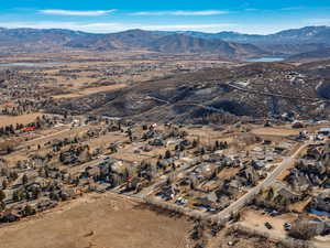 Aerial view of property's location with a mountain backdrop and nearby suburban area