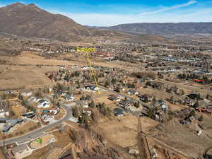 Aerial view of property's location featuring nearby suburban area and a mountainous background