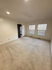 Unfurnished room featuring carpet flooring, recessed lighting, and crown molding