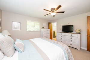 Bedroom with light carpet and ceiling fan