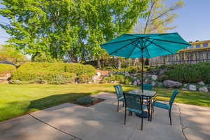 Fenced backyard with outdoor dining space and a patio