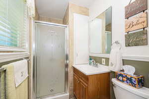 Full bathroom with a shower stall, vanity, and a textured ceiling