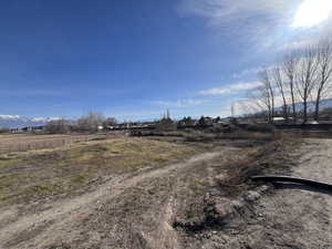 View of dirt / gravel road with a view of rural / pastoral area