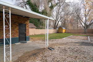 Fenced backyard with a storage shed