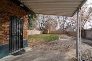 Fenced backyard with a patio and a shed